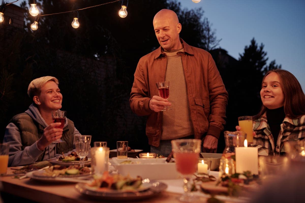 Adults laughing together at a backyard summer party