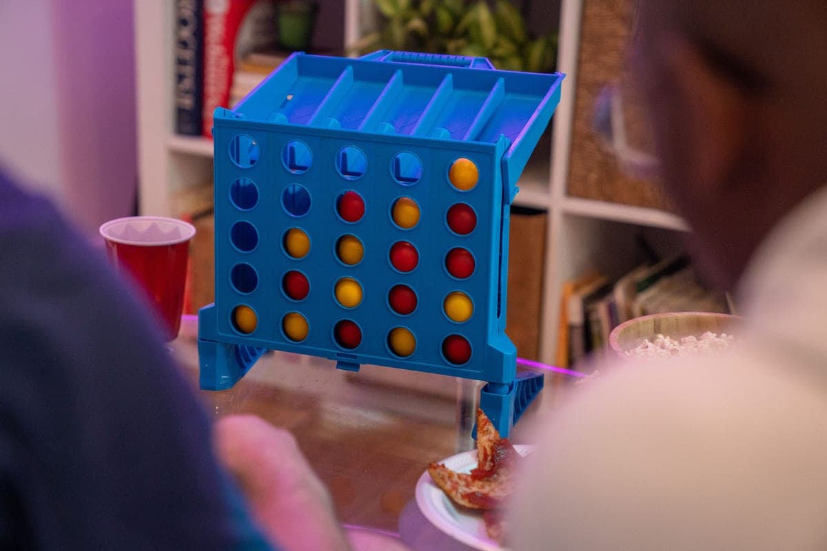A connect four style board game mid-play with colored discs