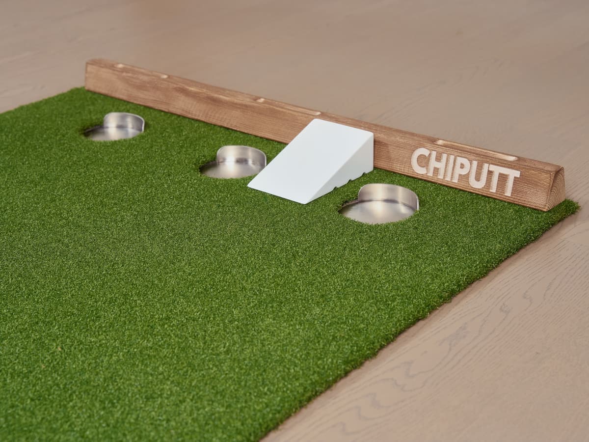 A wooden ladder toss frame beside a lawn game setup