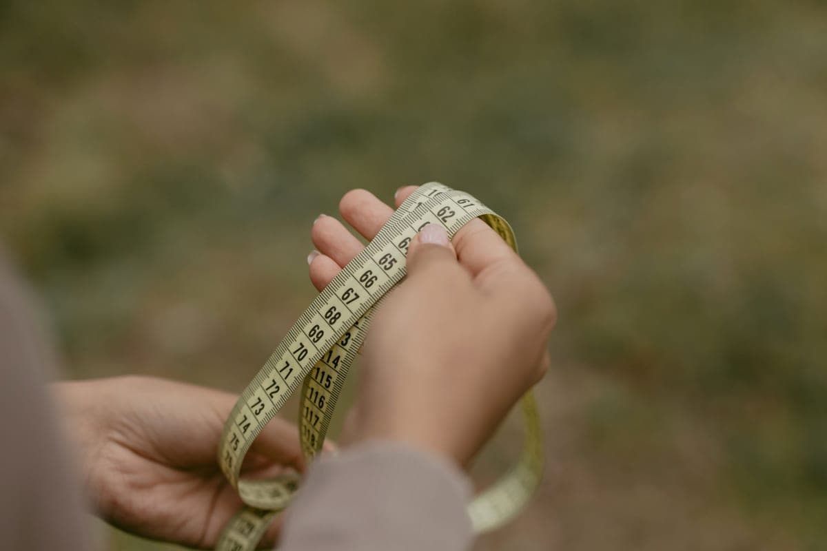 Measuring out a lawn area with a tape measure