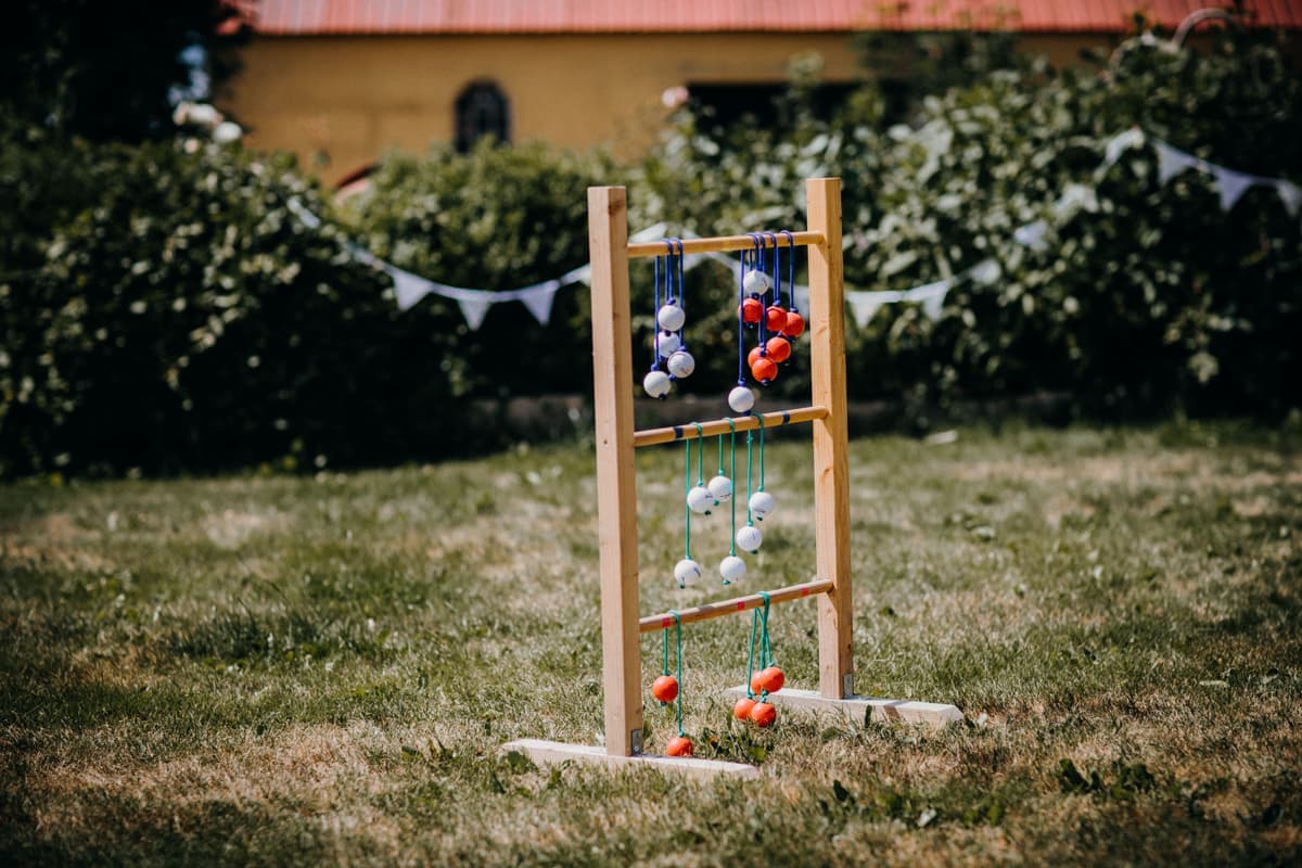 Balls rolling across a short grass lawn during a garden game