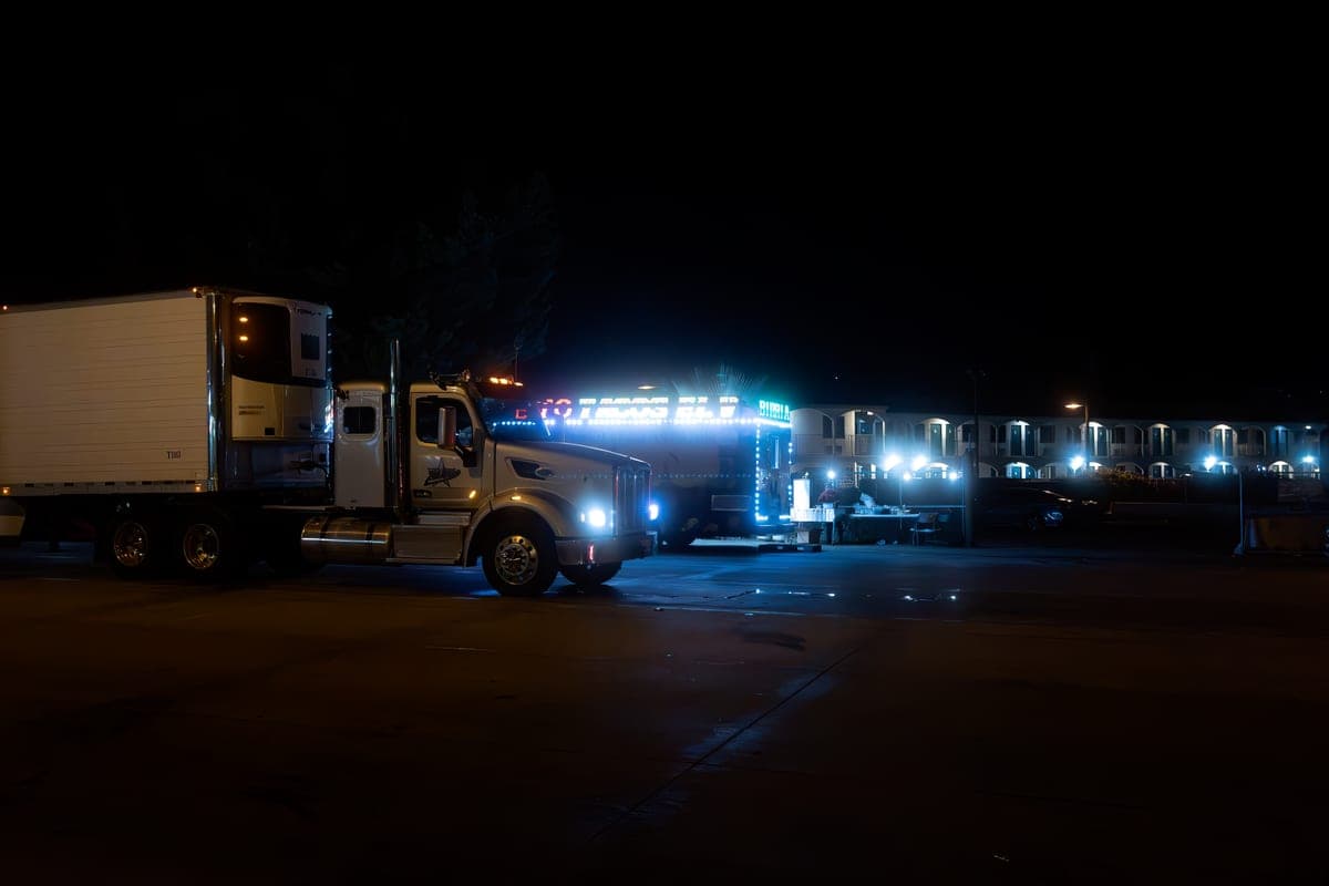 Friends gathered around a truck tailgate in a parking lot