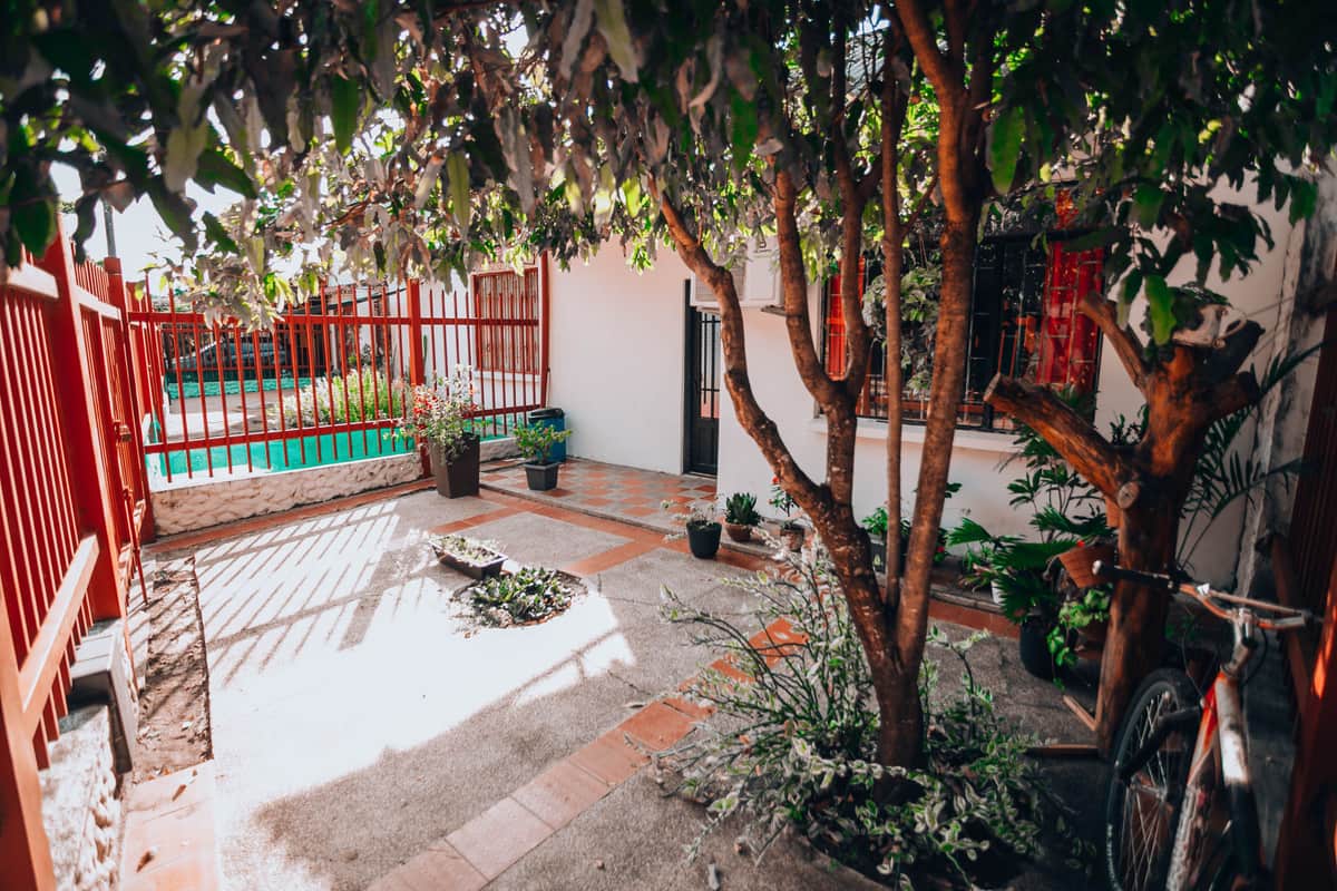 A small fenced backyard with a patio and a short strip of lawn